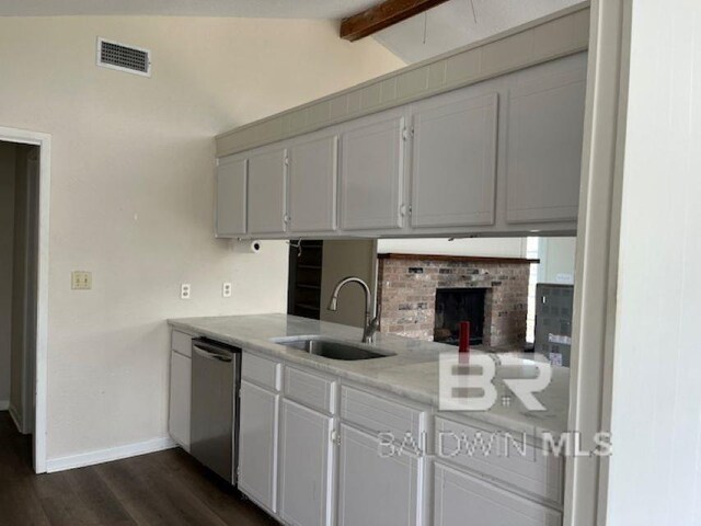 26225 Marina Rd, Orange Beach, AL 36561 - kitchen with stainless steel dishwasher, a sink, baseboards, dark wood-type flooring, and light countertops