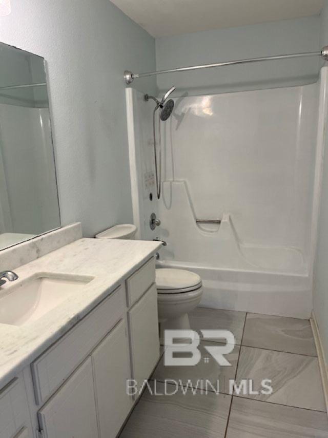 26225 Marina Rd, Orange Beach, AL 36561 - bathroom with toilet, vanity,  shower combination, and tile patterned floors