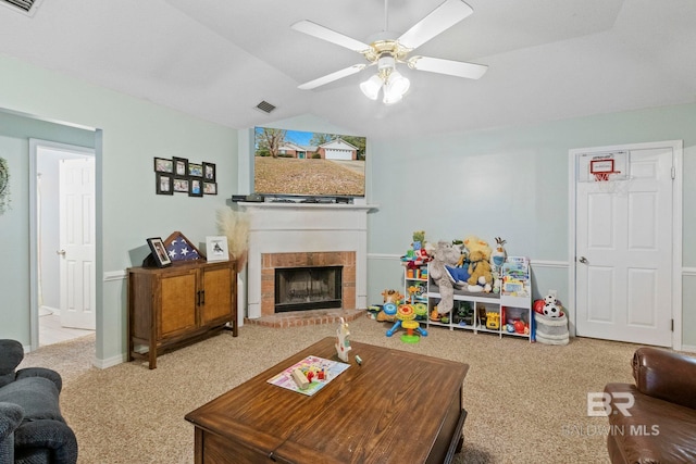 living room with ceiling fan, carpet, lofted ceiling, and a brick fireplace