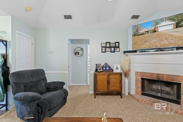 carpeted living room featuring lofted ceiling and a brick fireplace