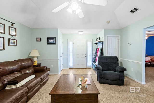 carpeted living room featuring ceiling fan and vaulted ceiling