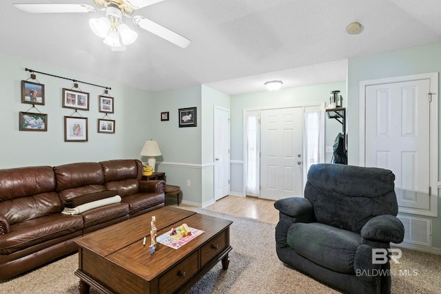 living room featuring light hardwood / wood-style floors and ceiling fan