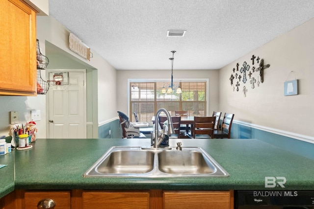 kitchen featuring dishwasher, a textured ceiling, a notable chandelier, and sink