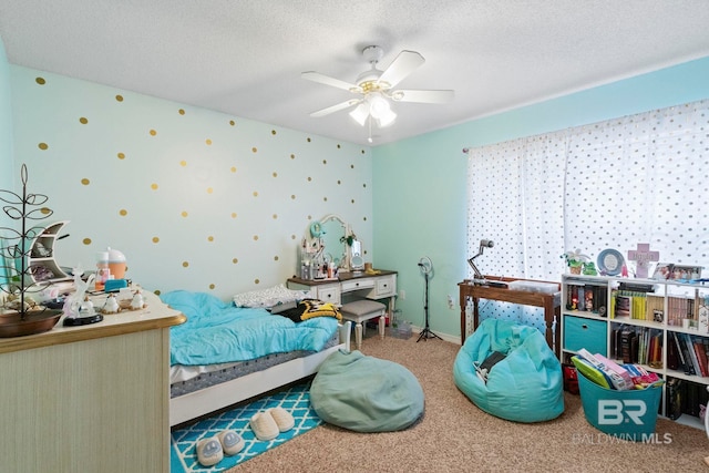 carpeted bedroom featuring ceiling fan and a textured ceiling