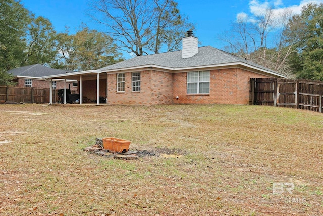 rear view of house with a lawn