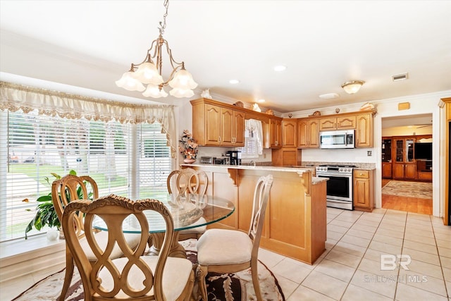 tiled dining room featuring ornamental molding and a notable chandelier