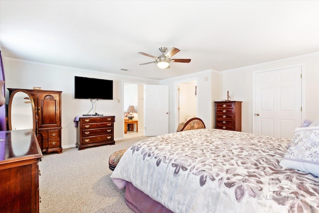 carpeted bedroom featuring ceiling fan and crown molding