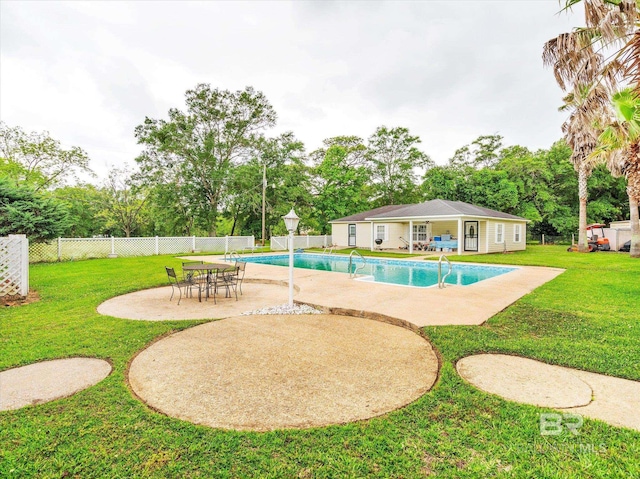 view of pool featuring a yard and a patio