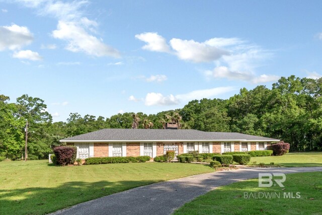 1180 Dawes Rd, Mobile, AL 36695 - view of front of house with gravel driveway, brick siding, and a front yard