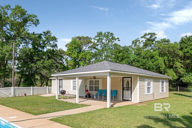 1180 Dawes Rd, Mobile, AL 36695 - rear view of property with a ceiling fan, roof with shingles, a patio area, fence, and a yard