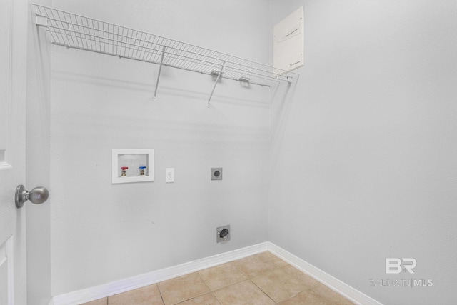 laundry area featuring laundry area, light tile patterned floors, baseboards, hookup for an electric dryer, and washer hookup