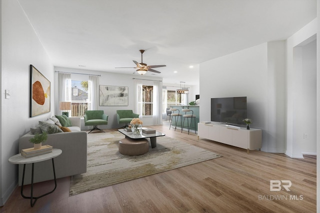 living area featuring recessed lighting, wood finished floors, a ceiling fan, and baseboards