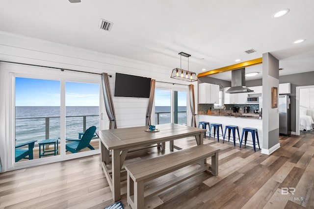 dining area with light wood-style flooring, recessed lighting, visible vents, and baseboards