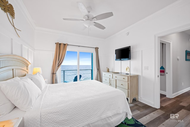 bedroom featuring access to exterior, a decorative wall, crown molding, and wood finished floors