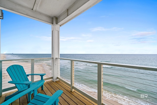 balcony with a beach view and a water view