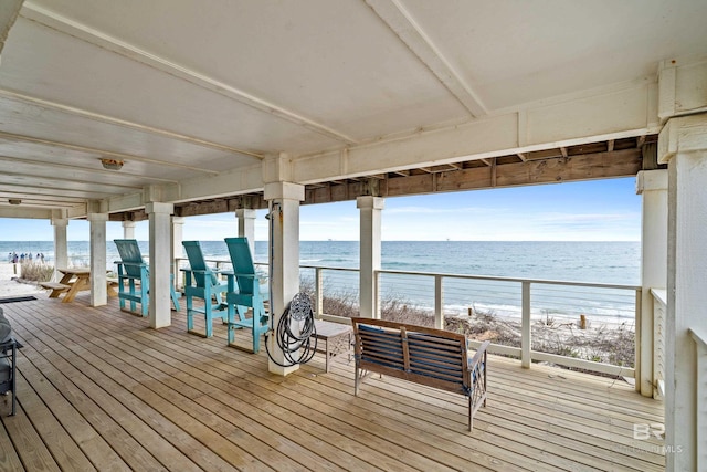 deck featuring a beach view and a water view