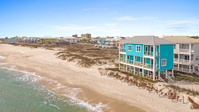 birds eye view of property with a residential view, a water view, and a view of the beach