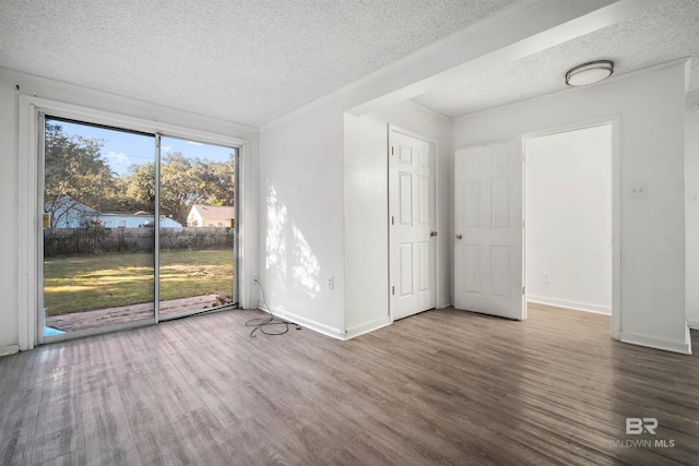 unfurnished room featuring a textured ceiling and wood-type flooring