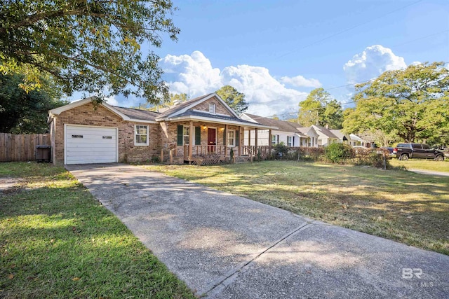 view of front of property with a front yard, covered porch, and a garage