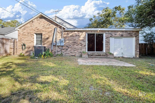 rear view of house featuring central AC, a yard, and a patio area