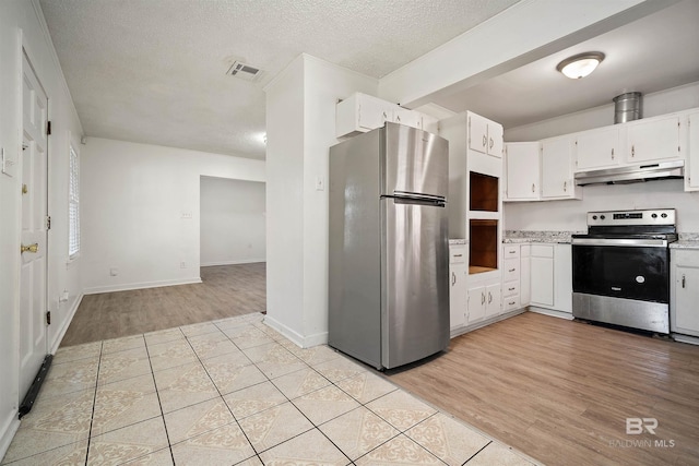 kitchen with light hardwood / wood-style flooring, stainless steel appliances, and white cabinets