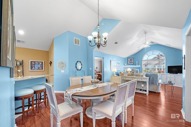 dining space featuring ceiling fan with notable chandelier, dark hardwood / wood-style floors, and lofted ceiling