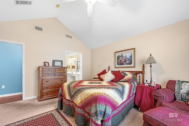 carpeted bedroom featuring vaulted ceiling, ensuite bath, and ceiling fan