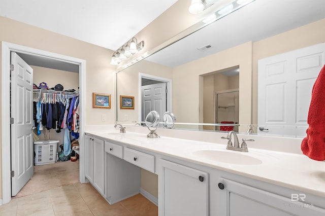 bathroom featuring tile patterned flooring, vanity, and an enclosed shower