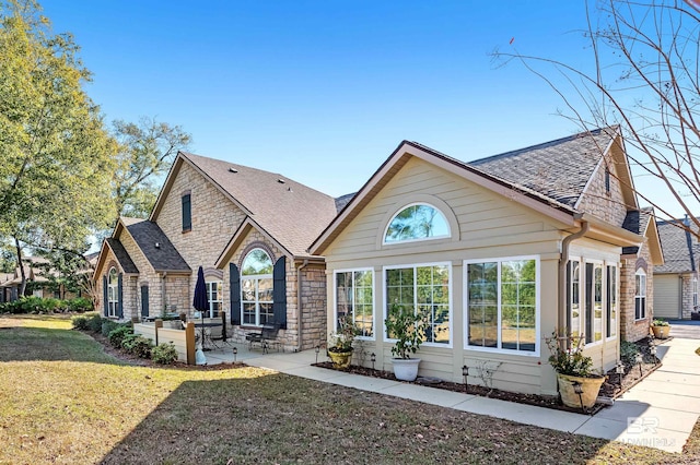 back of house featuring a lawn and a patio