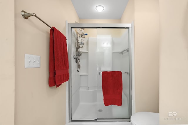 bathroom featuring toilet and walk in shower