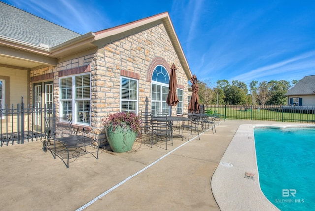 view of swimming pool featuring a patio area