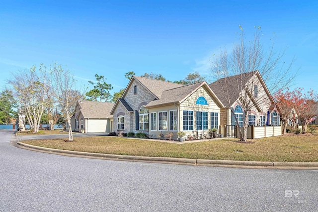 view of front of home with a garage and a front lawn