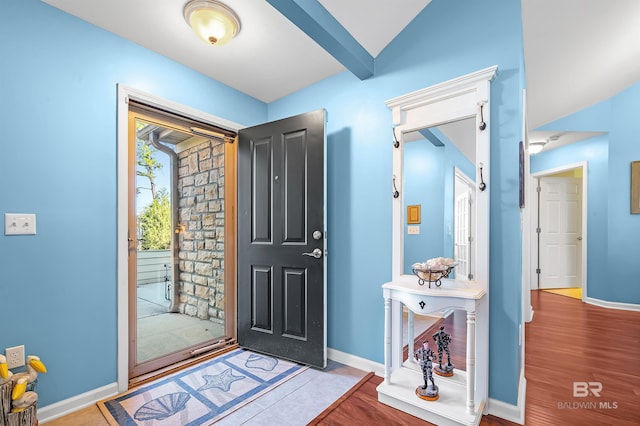 foyer with hardwood / wood-style flooring and vaulted ceiling