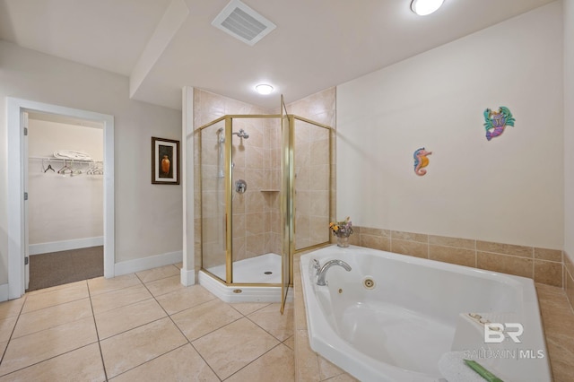bathroom featuring tile patterned flooring, visible vents, a shower stall, and a spacious closet