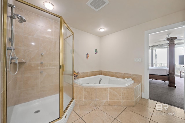 ensuite bathroom featuring connected bathroom, a garden tub, visible vents, and a stall shower