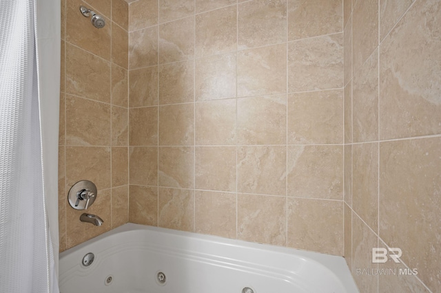 bathroom with a combined bath / shower with jetted tub