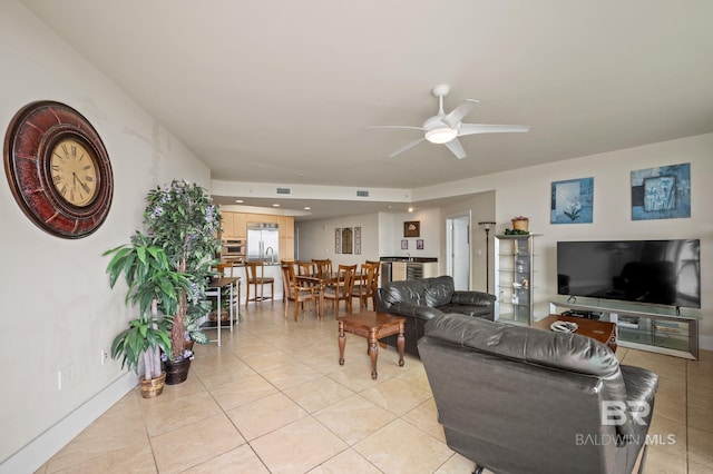 living room featuring light tile patterned floors, a ceiling fan, visible vents, and baseboards