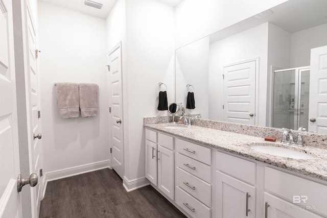 bathroom featuring hardwood / wood-style floors, vanity, and an enclosed shower