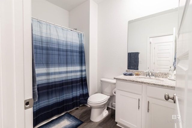 bathroom featuring hardwood / wood-style floors, vanity, toilet, and walk in shower