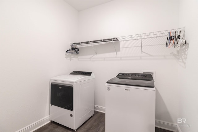 washroom featuring washer and dryer and dark wood-type flooring