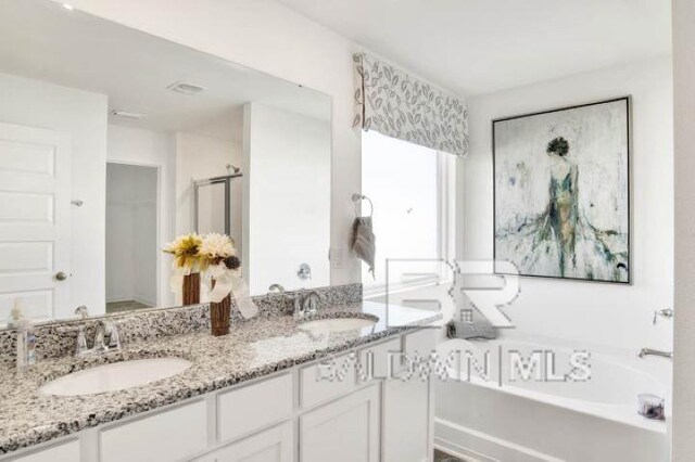 bathroom featuring vanity and plus walk in shower