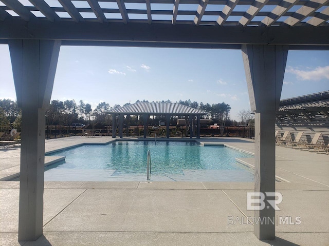 view of swimming pool featuring a patio area and a pergola