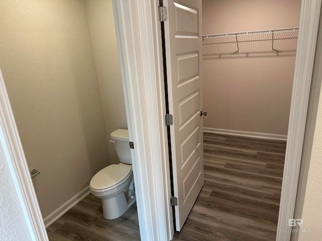 bathroom with wood-type flooring and toilet