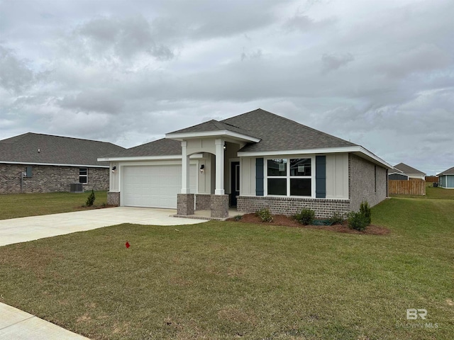 view of front facade with a front yard and a garage