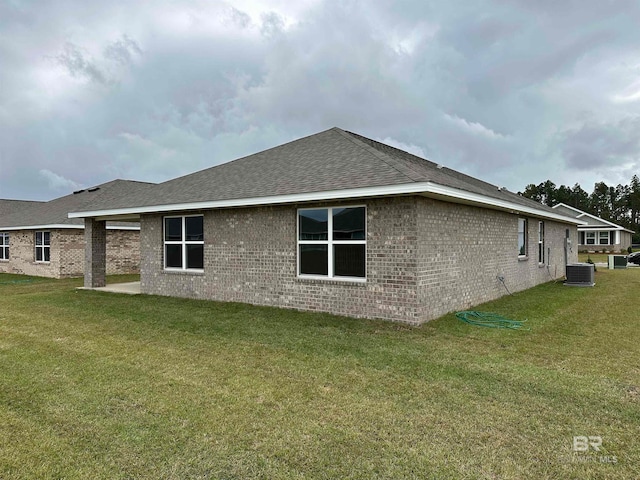 view of property exterior featuring central AC, a yard, and a patio area