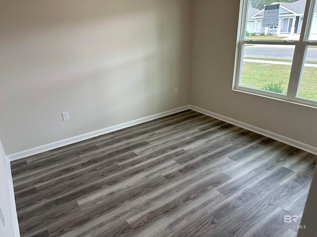 spare room with dark hardwood / wood-style floors