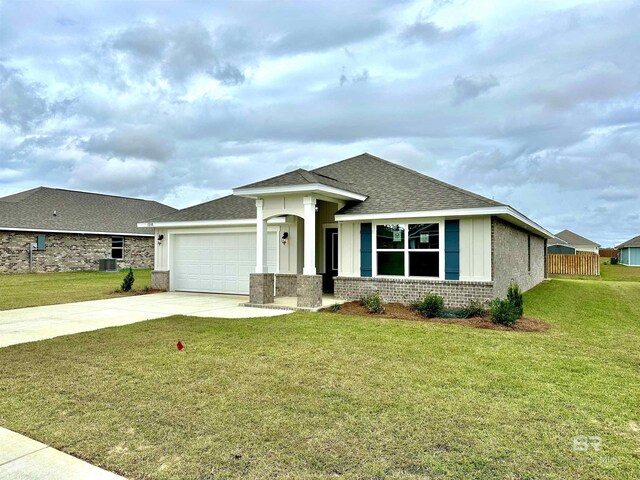 view of front of home featuring a front yard, concrete driveway, and brick siding