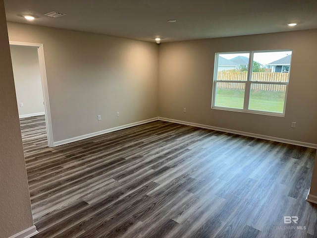 spare room featuring dark hardwood / wood-style flooring