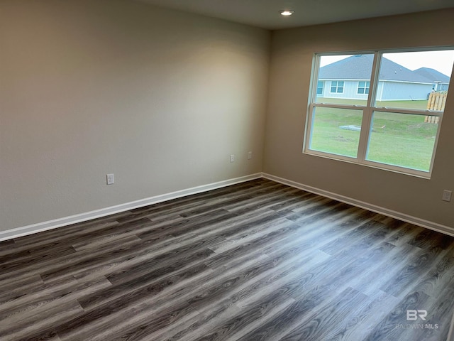 unfurnished room featuring dark wood-type flooring