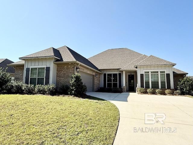 view of front facade with a front yard and a garage